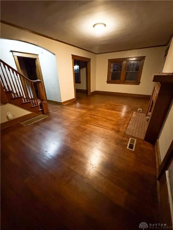 empty room featuring hardwood / wood-style flooring and ornamental molding