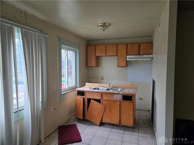 kitchen with sink and light tile patterned flooring