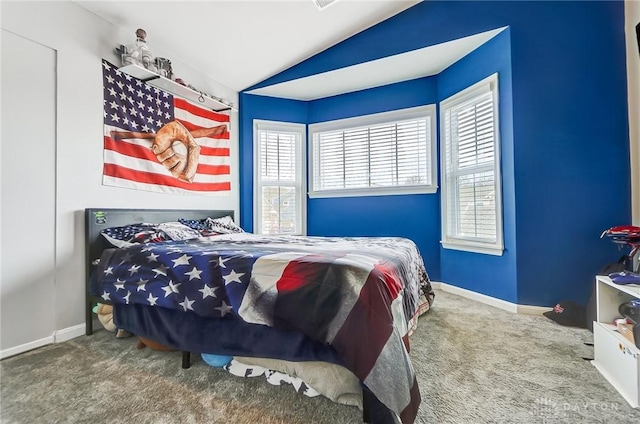 bedroom with lofted ceiling and carpet flooring