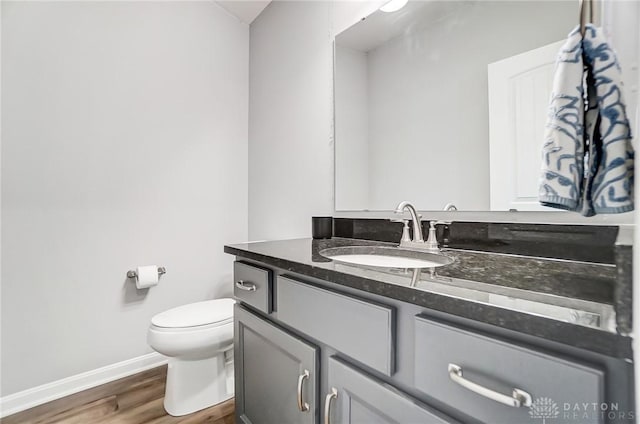 bathroom featuring hardwood / wood-style flooring, vanity, and toilet