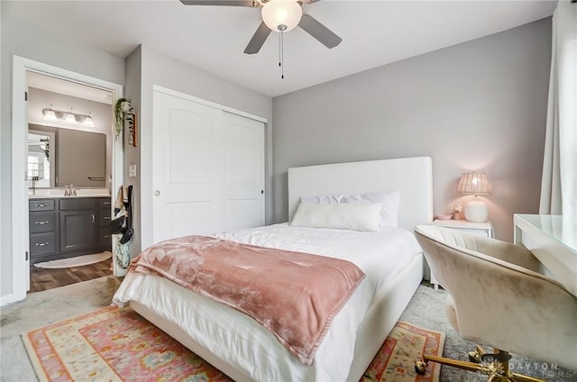 bedroom featuring sink, connected bathroom, ceiling fan, and a closet