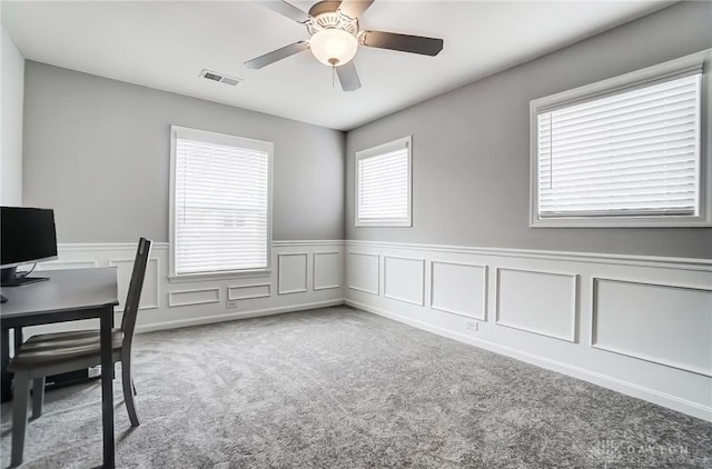 office with light carpet and ceiling fan