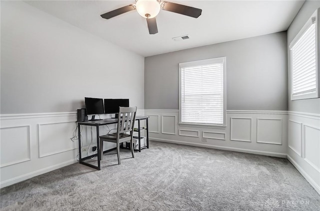 carpeted office with ceiling fan