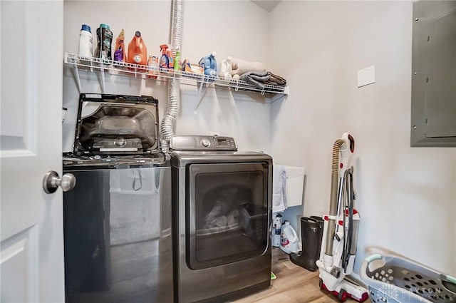 washroom with separate washer and dryer, hardwood / wood-style floors, and electric panel