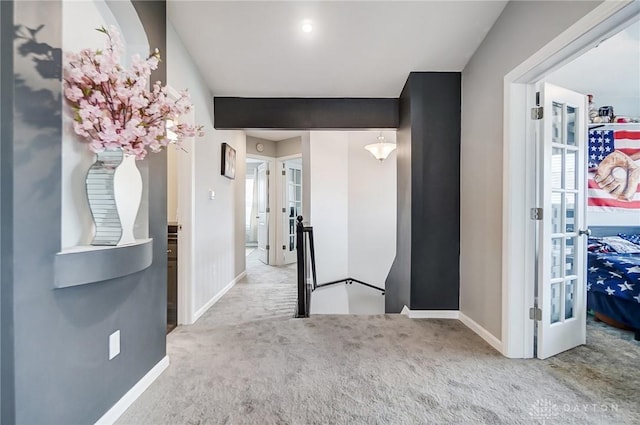 corridor featuring carpet flooring and french doors