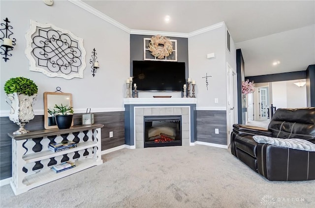 carpeted living room featuring crown molding and a tile fireplace