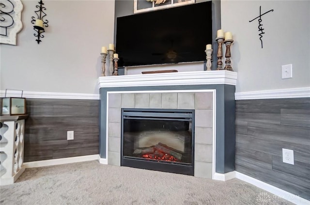 room details with a tiled fireplace and carpet