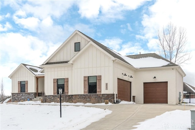 modern inspired farmhouse with a garage