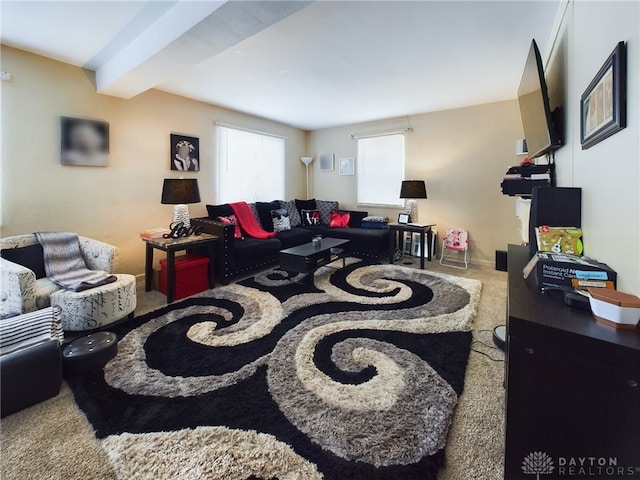 living room with beamed ceiling and carpet floors