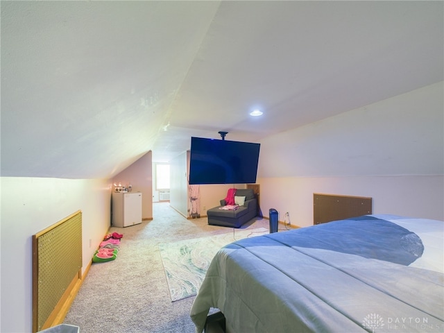 bedroom with lofted ceiling, washer / clothes dryer, and light carpet