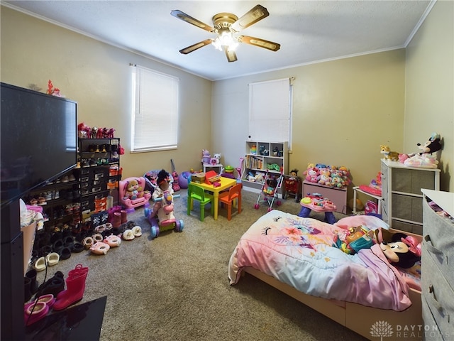 bedroom with ornamental molding, ceiling fan, and carpet