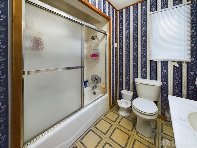 bathroom with enclosed tub / shower combo and toilet