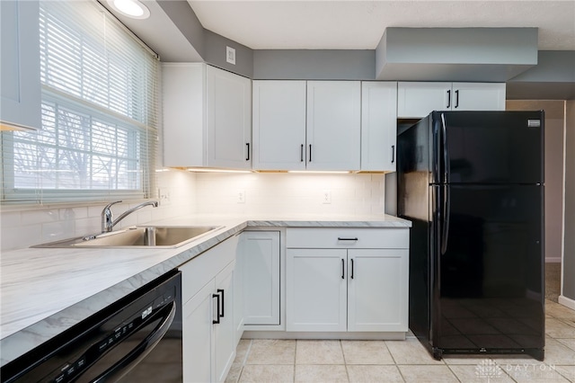 kitchen featuring white cabinetry, sink, backsplash, light tile patterned floors, and black appliances