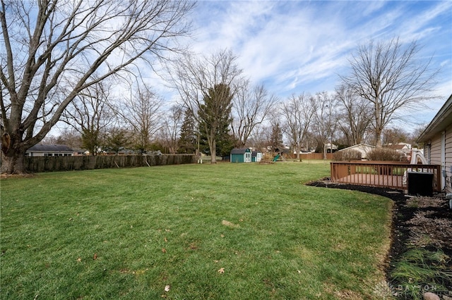 view of yard featuring a playground and a deck