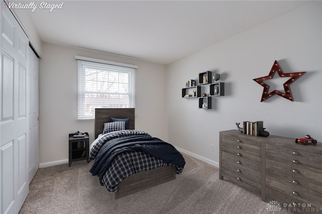 carpeted bedroom featuring a closet