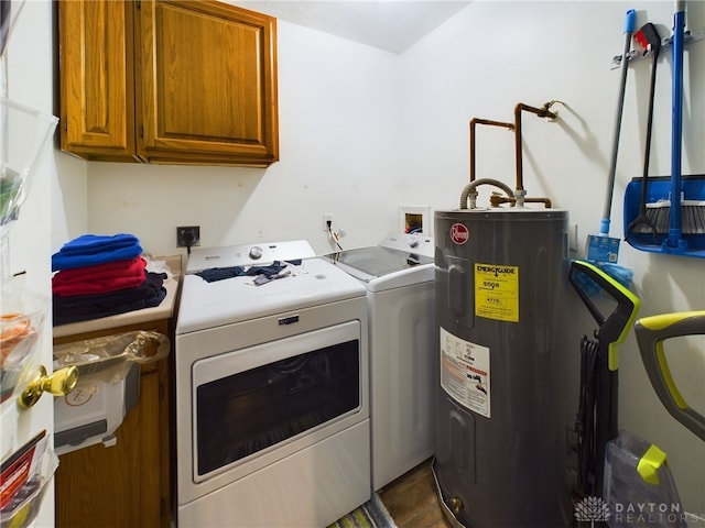 laundry area with washer and dryer, cabinets, and water heater