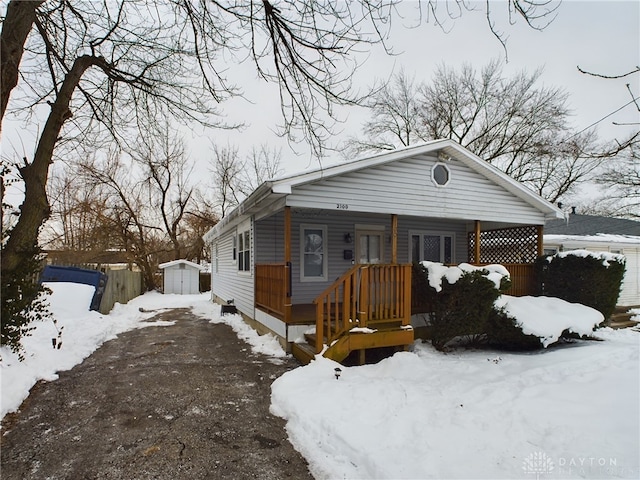 view of front of property with a storage shed