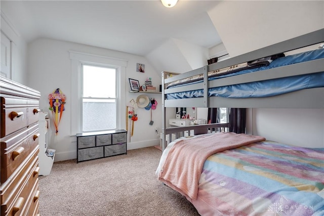 bedroom featuring lofted ceiling and light colored carpet