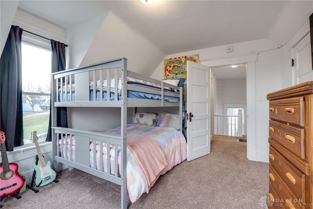 bedroom featuring vaulted ceiling and carpet flooring