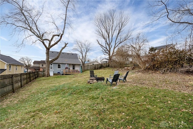 view of yard with a deck and an outdoor fire pit