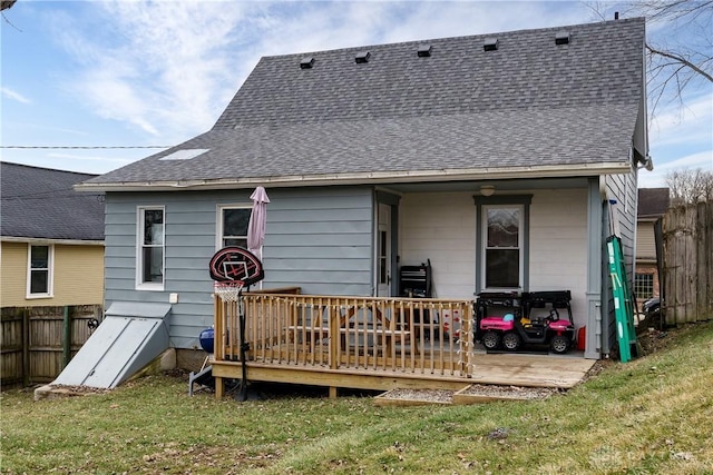 back of property featuring a yard and a deck