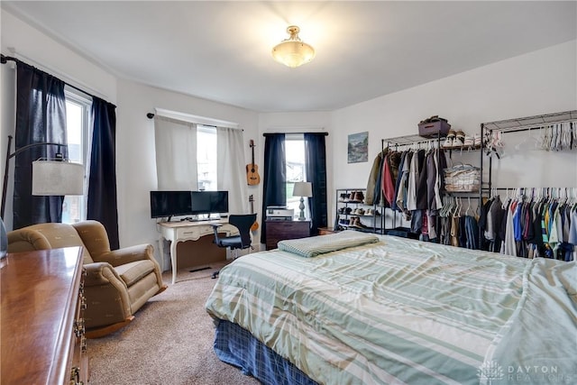 bedroom with multiple windows and carpet