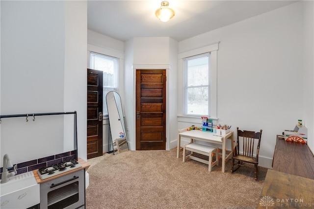 recreation room with a healthy amount of sunlight and carpet flooring