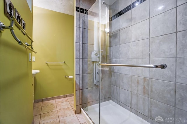 bathroom featuring tile patterned flooring and a shower with door