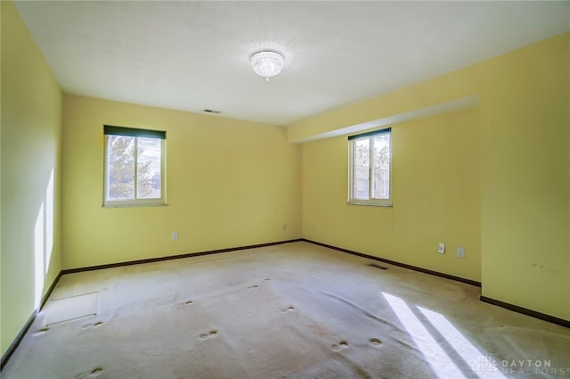 empty room with plenty of natural light and light colored carpet