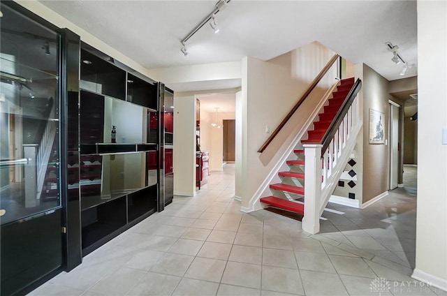 interior space featuring track lighting and tile patterned floors