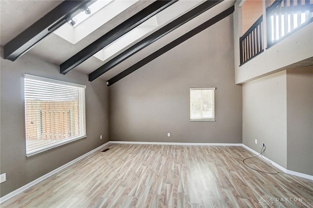 bonus room featuring high vaulted ceiling, a skylight, light hardwood / wood-style floors, and beamed ceiling