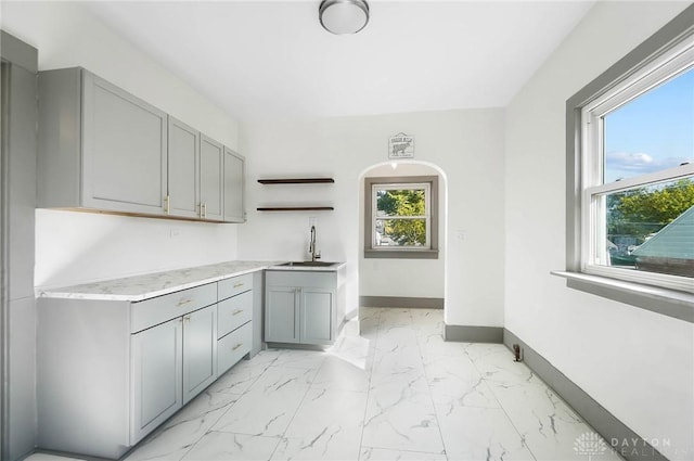 kitchen featuring gray cabinets and sink