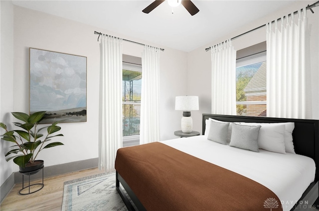 bedroom with ceiling fan and light wood-type flooring