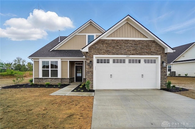 1507 Kingsgate, Springfield, OH 45502 - craftsman inspired home with stone siding, board and batten siding, concrete driveway, an attached garage, and central AC unit