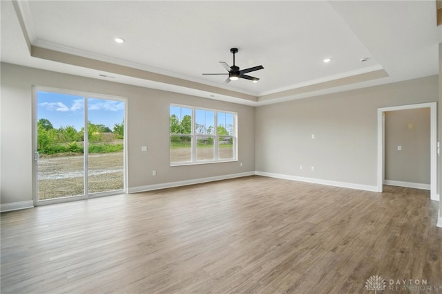 1507 Kingsgate, Springfield, OH 45502 - unfurnished living room featuring a tray ceiling, crown molding, ceiling fan, wood finished floors, and baseboards