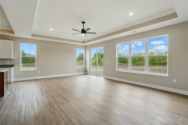 1507 Kingsgate, Springfield, OH 45502 - unfurnished living room with a tray ceiling, a ceiling fan, light wood-type flooring, baseboards, and recessed lighting