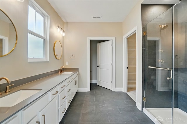 1507 Kingsgate, Springfield, OH 45502 - full bathroom with a shower stall, double vanity, tile patterned flooring, baseboards, and a spacious closet