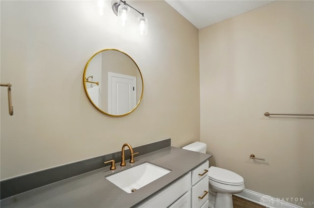 1507 Kingsgate, Springfield, OH 45502 - bathroom with vanity, toilet, baseboards, and wood finished floors