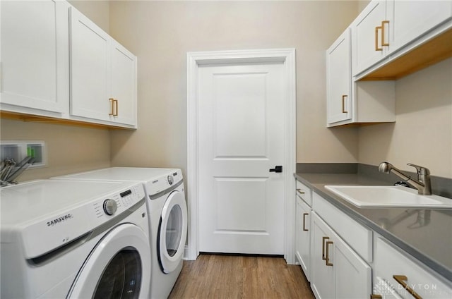 1507 Kingsgate, Springfield, OH 45502 - laundry area with independent washer and dryer, cabinet space, and wood finished floors