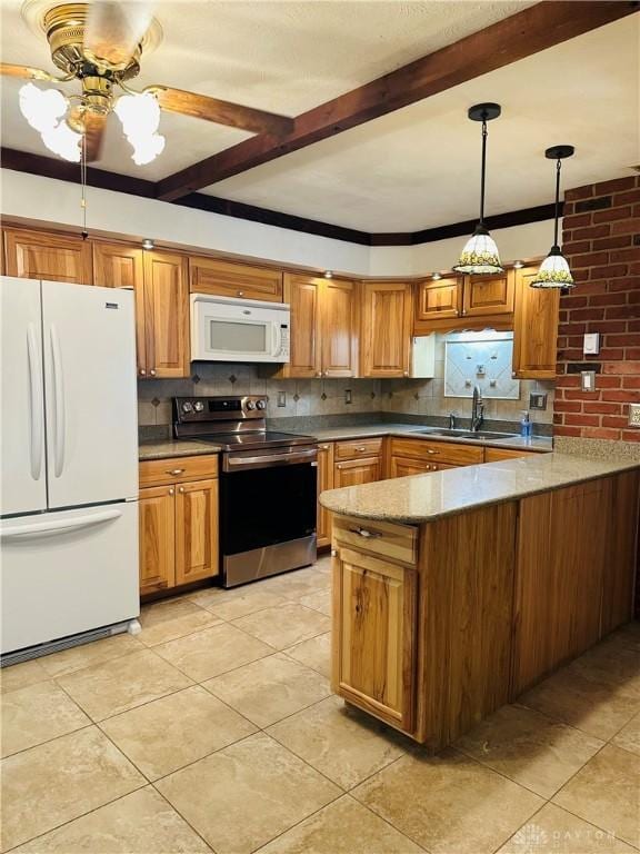 kitchen featuring beam ceiling, sink, white appliances, and kitchen peninsula