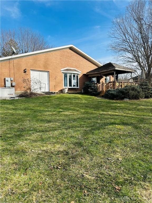 back of property with a gazebo and a yard