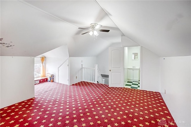 bonus room with vaulted ceiling, carpet floors, and ceiling fan