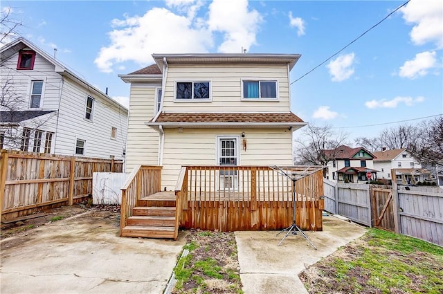 back of house featuring a deck