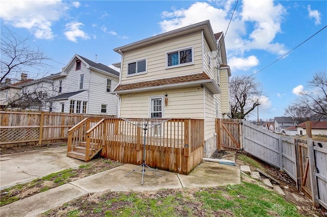 rear view of property with a deck and a patio