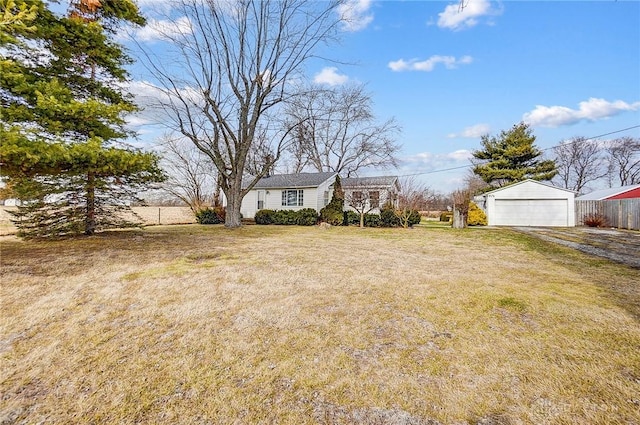 view of yard featuring a garage and an outbuilding