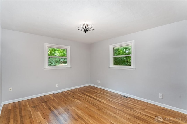 empty room with light hardwood / wood-style floors