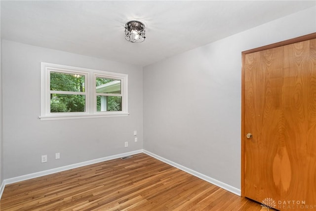 empty room with light hardwood / wood-style flooring