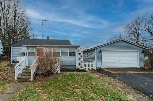 view of front of house featuring a garage and a front lawn