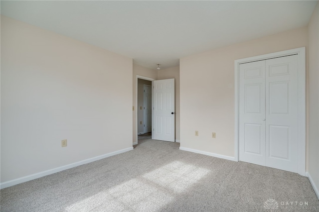 unfurnished bedroom with a closet and carpet