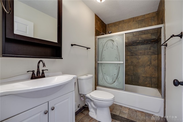 full bathroom featuring enclosed tub / shower combo, vanity, a textured ceiling, and toilet